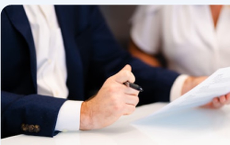 Person signing a Medicare enrollment form with an agent