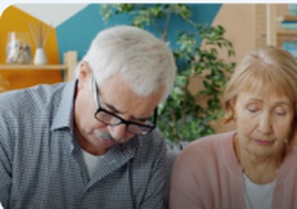 Senior couple learning about Medicare Parts A and B at home