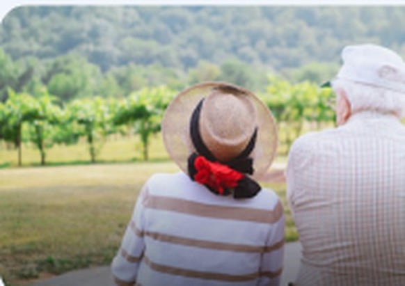 Retired couple relaxing outdoors in the countryside