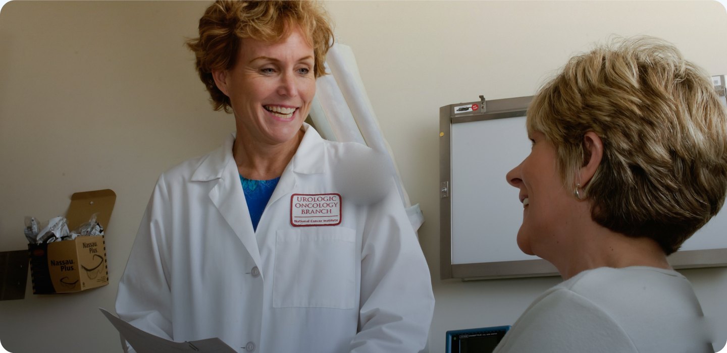 Medicare advisor in a white coat smiling while talking with a patient